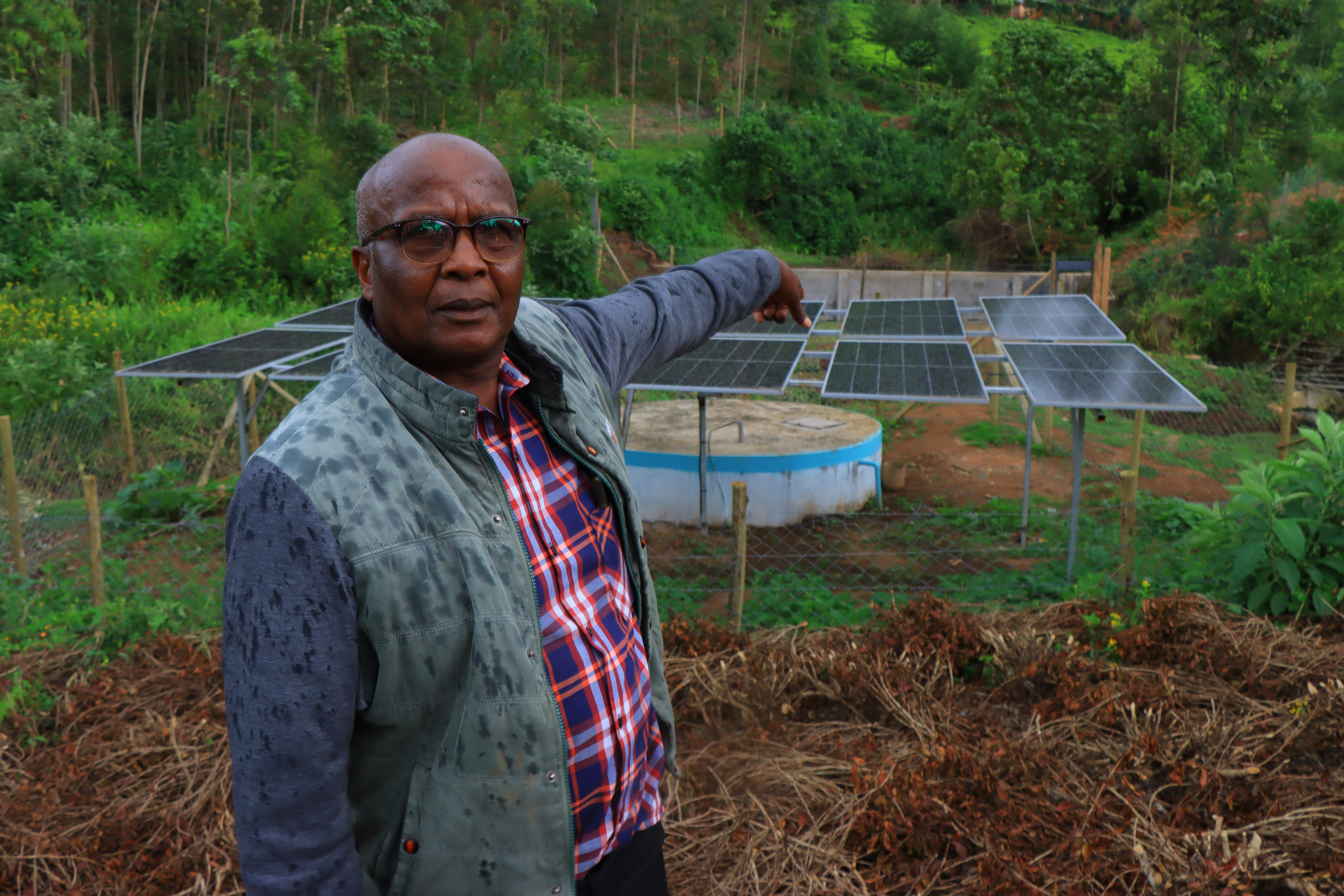 Joseph Korir, Chairman of the Oinab Tibik Stream Water Project, points at the ongoing project. IMG/EMMANUEL RONO