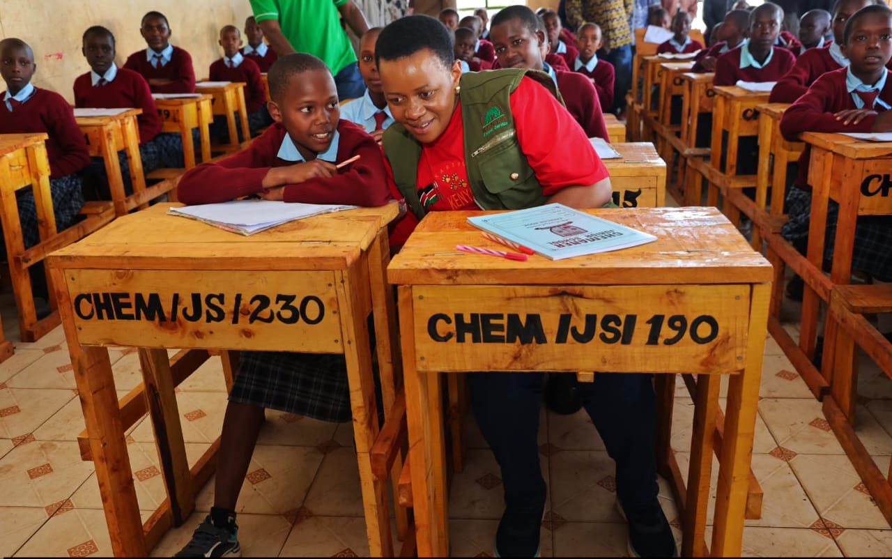 Parliamentary Affairs PS interact with Chemaner Junior school students during Mazingira Day fete. Photo/Kimagata Marindany