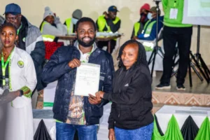 Ol Kalou MP-elect Sammy Kamau Ngotho and his wife display the IEBC certificate after being declared the winner in the Ol Kalou by-election. PHOTO/https://web.facebook.com/kamausammyngotho